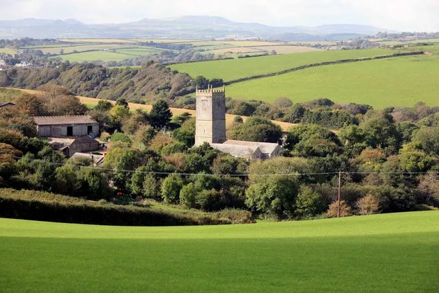 Lanteglos church Wonderful view here looking at Lanteglos church and then over Mid Cornwall with the clay tips above St Austell in the distance. Of course this view does not show the steep valleys in between. Beyond the church hidden is the river Fowey and Pont Creek.