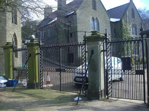Gate piers, gates and iron railings to south and east of churchyard at Church of St Nicholas