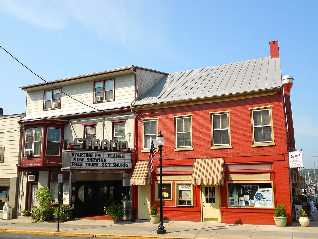 Buildings in the Hamburg Historic District, listed on the NRHP on June 28, 2010. The historic district is roughly bounded by Franklin, Windsor, Walnut and Second Sts., Quince, Primrose, Peach and Plum Alleys and Mill Creek in Hamburg, Berks County, Pennsylvania. The building on the left is the Strand movie theater, at the center of town (and of the historic district) at 4th and State Streets.