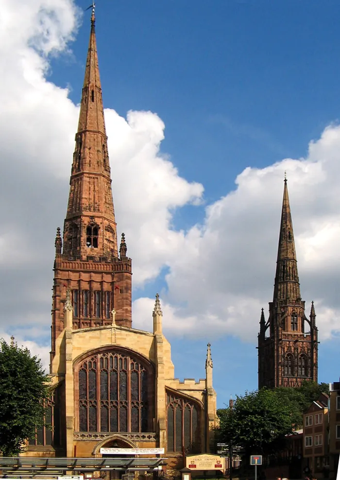 Holy Trinity parish church (left) and the tower and spire of St Michael's Cathedral (right) in central Coventry, England