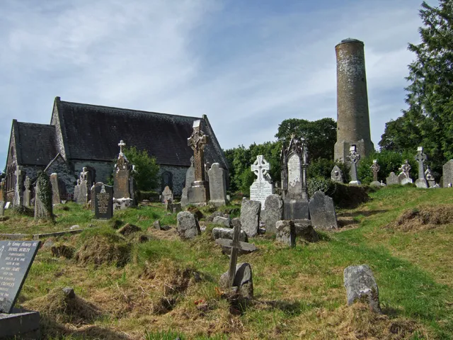 St Bartholomew's Church and Round Tower at Kinneigh Overlooking St Bartholomew's C of I parish church and graveyard, is the unique round tower of Kinneigh, the only surviving building of an early monastery. It was built sometime during the C11, and is unique in Ireland, as apart from its great age (1000 years), it is the only example of a round tower with a hexagonal base. Round towers were prominent in many Irish monasteries, and were in use primarily as bell towers. They may well have had a secondary use as a store for relics, or even used for defensive purposes during times of unrest. The tower would originally have been capped with a pointed conical roof.