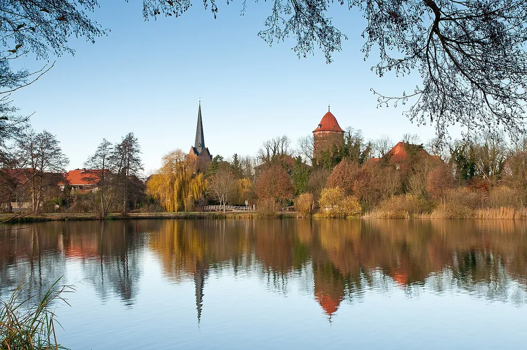 View from the lake "Thielenburger See" to the old town skyline of Dannenberg (Elbe) in late autumn. You can see both town landmarks, the church St. Johannis and the castle tower "Waldemarturm".