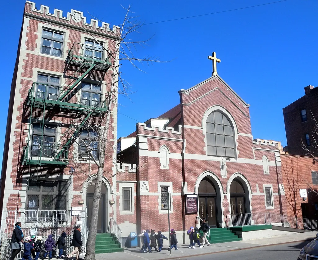 Looking northeast across 138th St at St Mark's on a sunny midday.