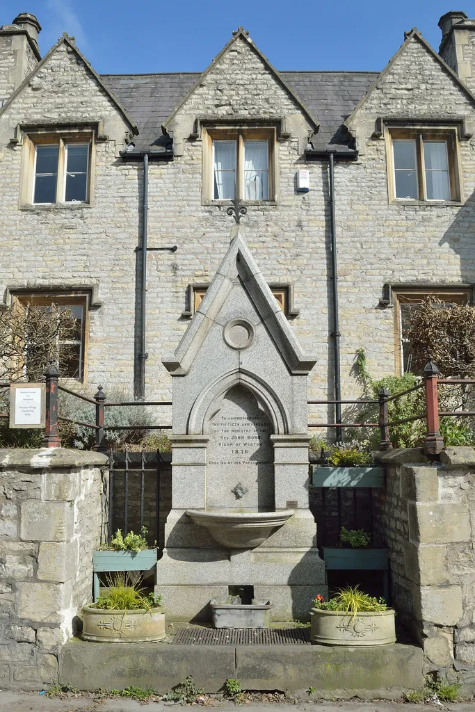 Drinking fountain on High Street, Weston, Bath. It is in a recess of wall in front of the All Saints Church Centre. Inscription states "To commemorate the fiftieth anniversary of the ministry of the Rev John Bond, Vicar of Weston 1876 - Erected by his parishioners".