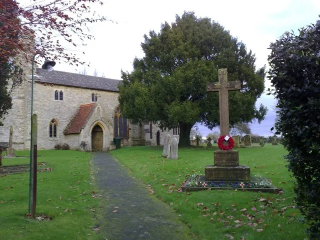 St Michael and all Angels church, Finmere, Oxfordshire, with the parish war memorial in the foreground