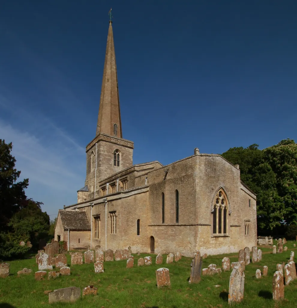 Parish church of SS Peter and Paul, Church Hanborough, Oxfordshire, seen from the southeast. The church is 12th century but was remodelled in about 1399, which may be when the spire was added.