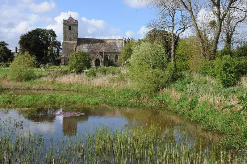 Yarkhill church and moat. Yarkhill church is dedicated to St John the Baptist. With exception of the west tower and the south doorway both of which are 13th century, the church was completely rebuilt in 1862 by Ainslie and Blashill. The moat in the foreground surrounds a site which has been excavated revealing the foundations of a late 12th, early 13th century building.