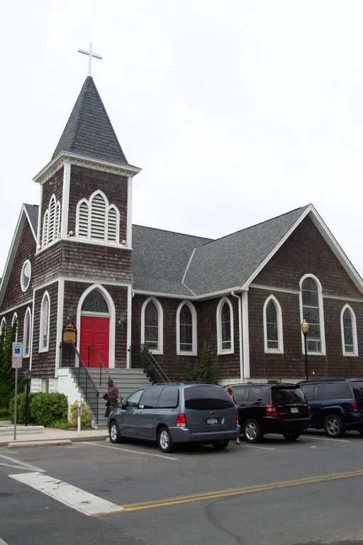 Parking lot view of St. Paul's by-the-sea Protestant Episcopal Church, located at 302 N. Baltimore Street in Ocean City, Maryland, United States. Built in 1900, the Gothic Revival church is listed on the National Register of Historic Places. Church website.