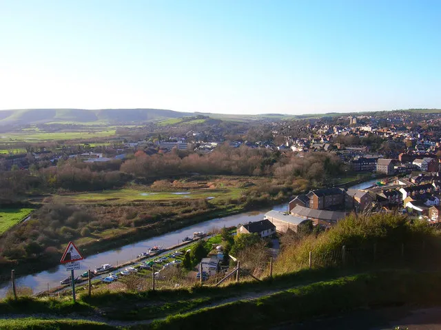 Cliffe Cut, River Ouse Taken from the cliff on Chapel Hill near the golf club and looking down onto the town. The stretch of river in the foreground is Cliffe Cut undertaken when the Ouse was canalised in the late 1790s. The original course of the river meandered to the east by the boathouse next to Hilman Close, the circular set of flats. Beyond the river can be seen the Heart Of Reeds which can be found 291632 along with an opposite view. It was also at this point that Britain's worst ever avalanche occurred on Christmas Eve 1836 when a 15 foot snowdrift perched on this cliff top collapsed onto houses below killing 8 people. The current Snowdrop Inn below is named after this event. Other views which can be taken in include the castle to the right and the downs at Kingston ridge on the left hand side.