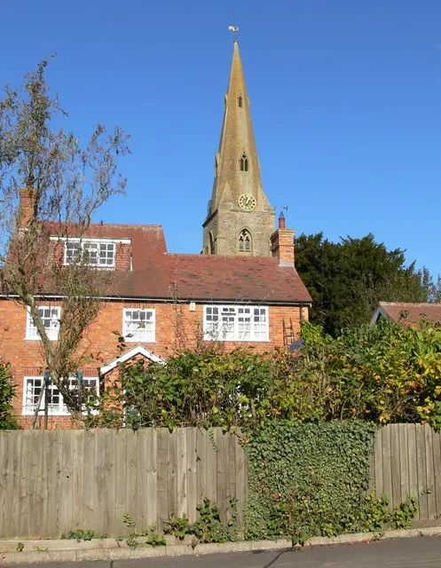 A house in Walcote Road, South Kilworth, Leicestershire, with the west tower and broach spire of St Nicholas' parish church behind