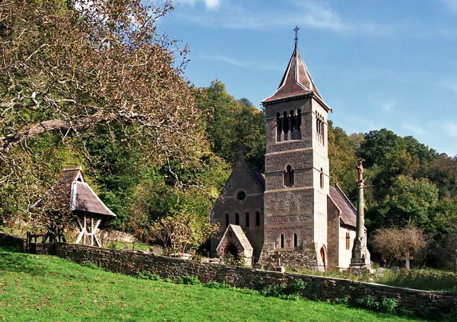 St Margaret's parish church, Welsh Bicknor, Herefordshire, seen from the west. To the right of the tower is the 19th-century churchyard cross.