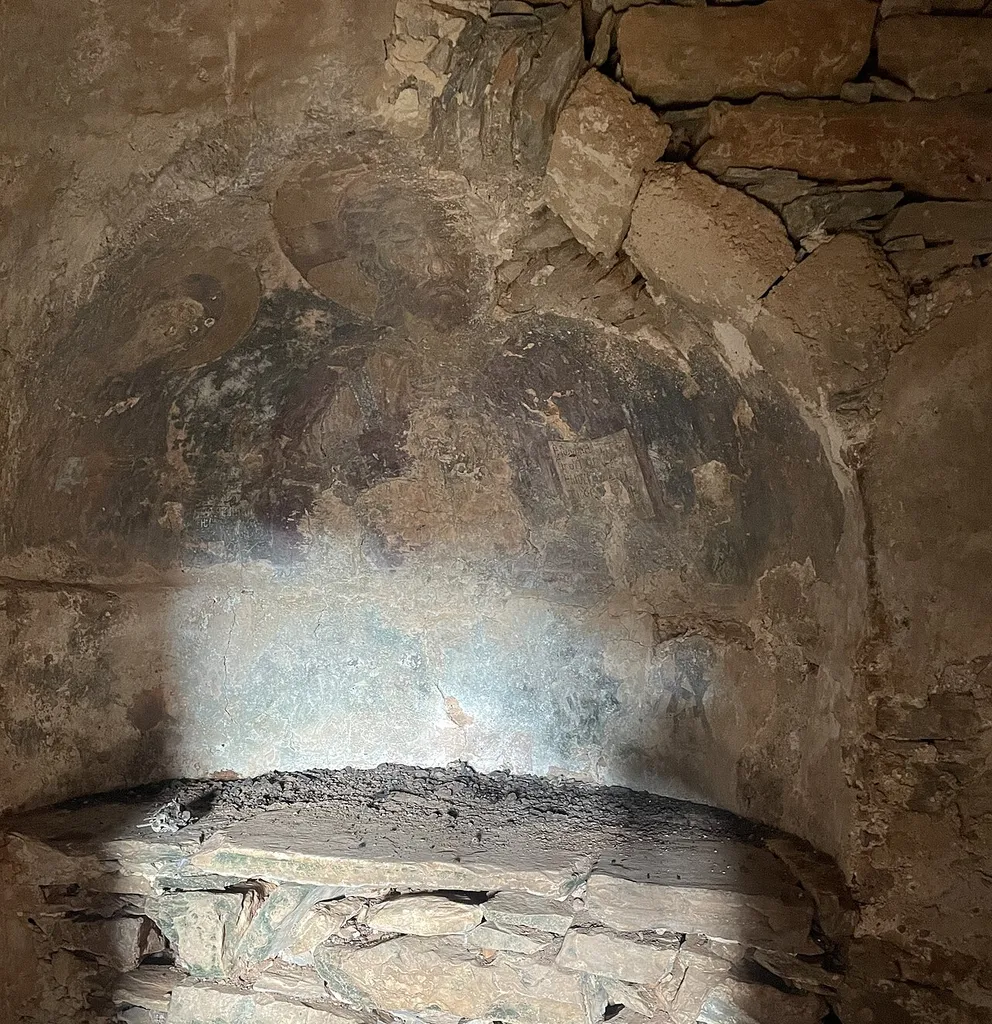 interior apse of of Agios Georgis chapel in Distomo, Naxos, showing damaged wall painting of Christ