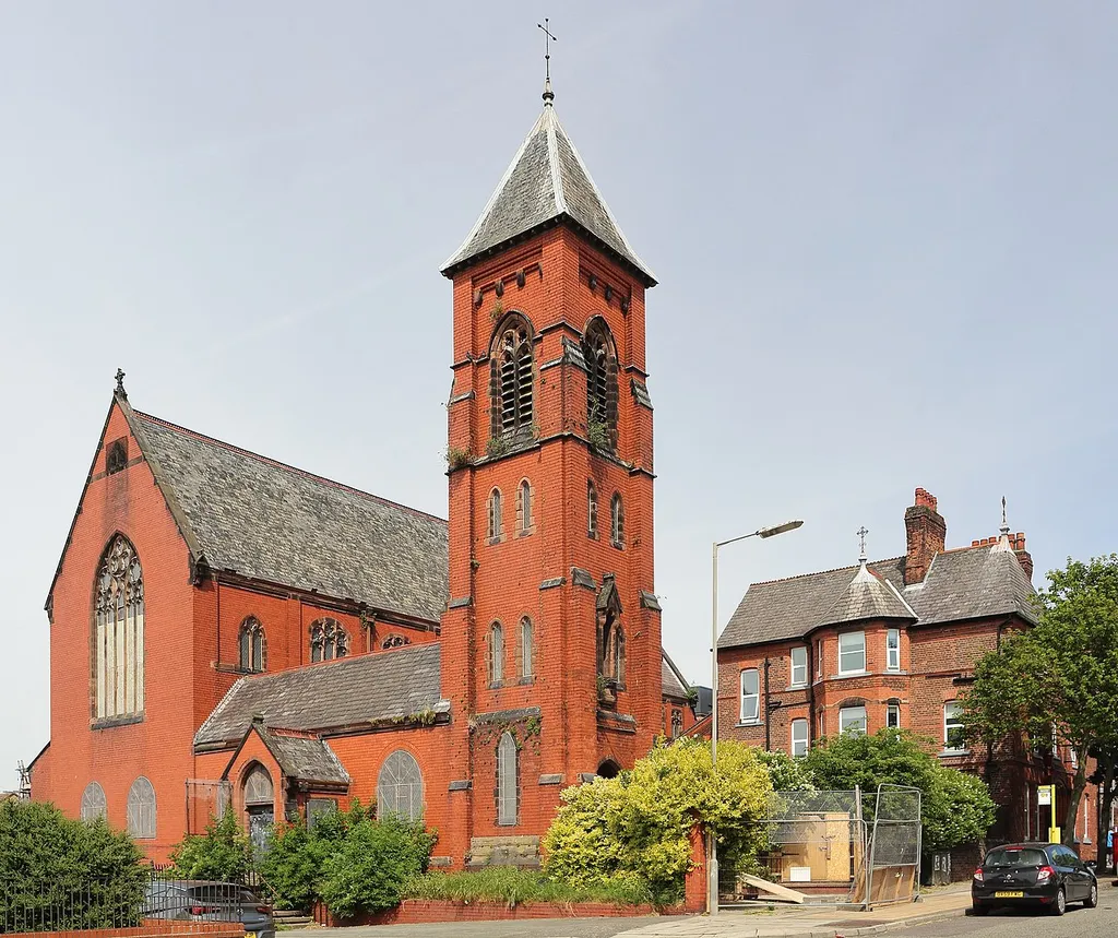 Gothic revival Roman Catholic church, 1889, in Vauxhall, Liverpool. Designed by Pugin &amp; Pugin in Ruabon red brick. Its presbytery, now detached and sold off, is at the right.