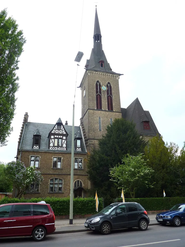Roman-catholic Sacred Heart Church in the district of Fechenheim in Frankfurt am Main, Hesse, Germany. General view with rectory (left), seen from the east.