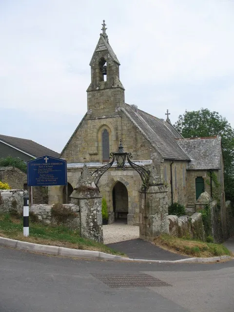 St. Levan's, Porthpean. A view looking east across the steep road to Porthpean Beach, towards the church of St. Levan.
