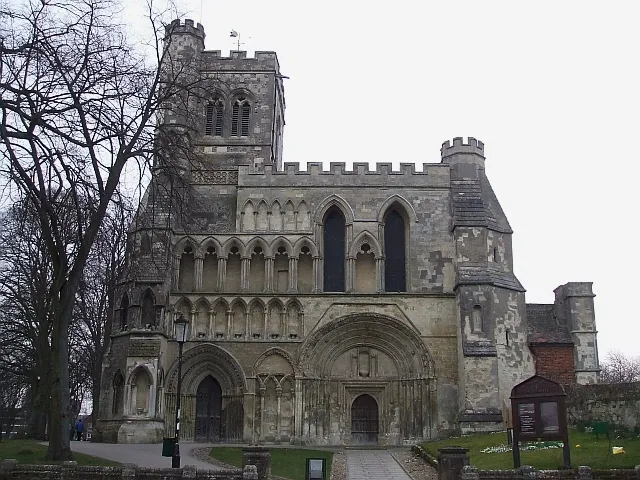 Priory Church of Saint Peter, Dunstable. Once part of a far larger group of buildings forming the Augustinian Priory of St Peter, this parish church is still a very impressive structure. The arch above the main doorway is typically Norman with concentric semi-circular arches (see close-up 1760647). However much of the rest of this façade is of the later Early English period, with pointed arches. This is due to much damage that occurred to the church in storms in 1222