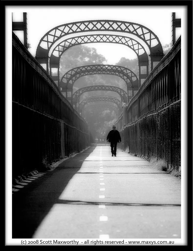 Man walking across the old Como railway bridge