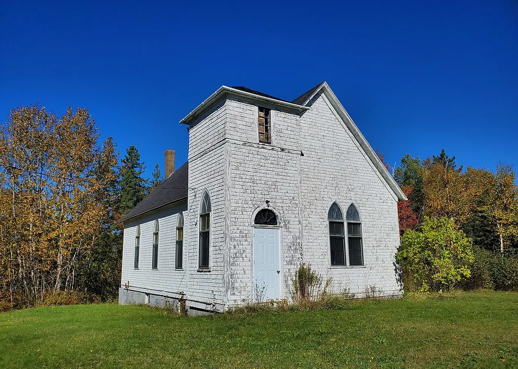 Abandoned church built in 1929. Orangedale Presbyterian Church, located at 1365 Orangedale Road in Orangedale, Nova Scotia, Canada, photographed on 11 October 2022.
