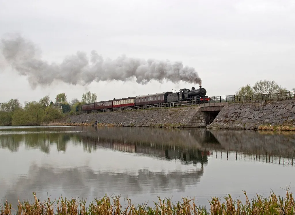 Preserved steam locomotive S&amp;DJR 7F 2-8-0 No. 53809 crossing Butterley Reservior at the Midland Railway - Butterley heritage railway.
