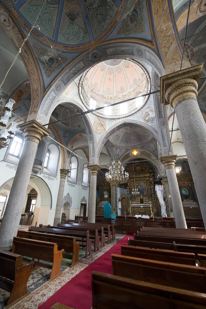 One of a series of pictures of this church. Its website has: "Surp Kirkor Lusavoric Church is known as the oldest Armenian Orthodox Church in Kayseri.First mentioned of in 1191, after having numerous renovations our church was able to survive till present.Whilst about to collapse in the mid 19th century it was started to be rebuilt in 1859 and completed with financial supports of tradesmen in meat business, artists and laborship efforts of men women and children from different classes of society. Even though this church is rather smaller than the ones in Kayseri, yet having been surrounded by Armenian neighborhood gives it a very cozy atmosphere. Gumusyan School located next to it is currently a ruin. After this major renovation , a marble tablet was placed above the main gate on which the details of the renovation were explained. In 1996 it was opened for worships by 2 charitable Kayserian brothers. Our church was built on a 3 nave basilica plan. The mid nave is seperated from side naves. Interior is built with arcs in direction of North-South, East-West. These arcs constitute 3 rectangle and a square section.Top of the mid nave and east&amp;west sections are vaulted, side naves are ovale vaulted and cross arch barrels. The west side consists of a nartex covered with 3 cross arch barrels. On top of this nartex is placed the gallery. The entrance of the church is built with 5 columnsand a half dome. The worship section is decorated with frescoes and the paintings of Saints. Completed in 1191, the 820 year old Surp Kirkor Lusavoric church which was founded in 1461 with the mandate of Fatih Sultan Mehmet Han was dependent to Istanbul Armenian Patriarchate and stands still with supports of donators and the board of foundation. Being the oldest in Middle Anatolia this church is known as the only Armenian Church that is open for worships. " I am not certain if the last sentence is still correct.