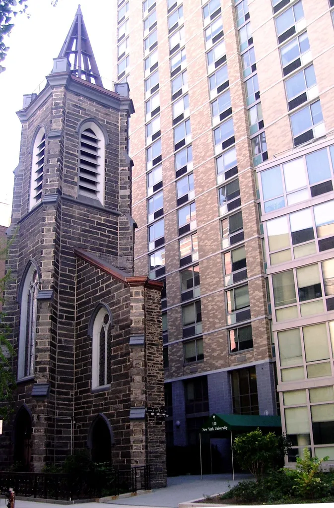 The facade of St. Ann's Church stands in front of New York University's 26-story Founders Hall dormitory at 120 East 12th Street in Manhattan, New York City. The church building was constructed in 1847 as the Twelfth Street Baptist Church, then was bought by Congregation Emanu-El, which later moved to a new sanctuary on Fifth Avenue. Napoleon LeBrun designed a new interior, and in 1871 St. Ann's Roman Catholic Church was dedicated. In 1983, this became St. Ann's Armenian Catholic Cathedral, until everything except the front facade was torn down for the dormitory, which opened in 2006. (Sources: From Abyssinian to Zion (2004) and NYC GIS map)