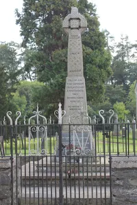 Parish War Memorial at St Dogfan's Church with surrounding railed enclosure.