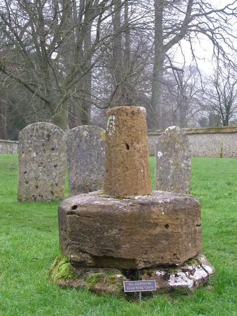 Preaching cross at Cerne Abbas burial ground These are the remains of a 15th century preaching cross, made of hamstone - a golden coloured limestone that is quarried at Ham Hill near Montacute.