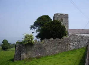 Churchyard boundary walls, including East Lychgate, at Church of St Mwrog