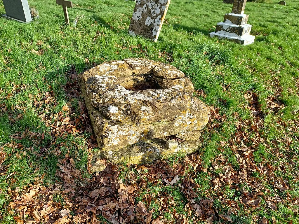 Base of a medieval churchyard cross at St Bartholomew's Church, Oake, Somerset, England. Probably 14th century, Grade II listed.