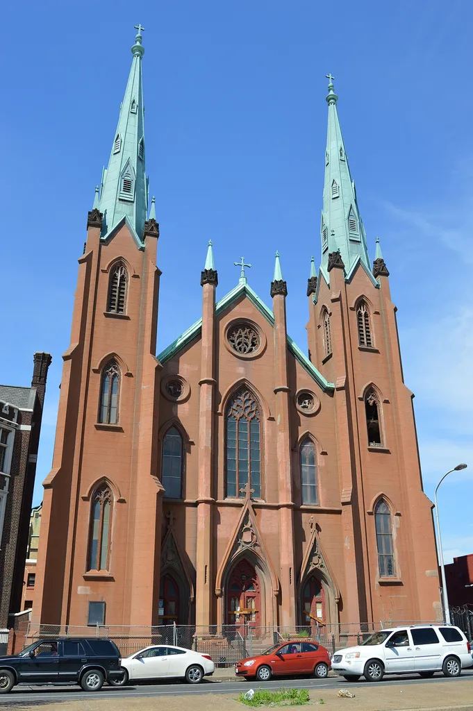 Front of the former Church of the Assumption, located on the northern side of Spring Garden Street just east of the Ridge Avenue intersection in Philadelphia, Pennsylvania, United States. Built in 1849 and extensively modified in 1899, it is no longer in use; the signs on the doors (not legible in this image) are city-placed notices of demolition.