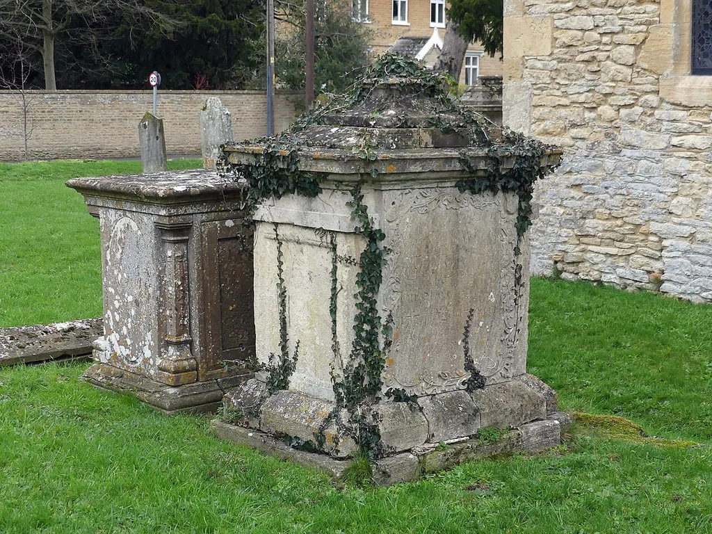 Grade II listed pair of chest tombs at St Mary the Virgin's Church, Bampton, Oxfordshire. Listed as "Pair of chest tombs to Shingleton family, in churchyard of St Mary's, circa 4 metres west of nave". .mw-parser-output .messagebox{margin:4px 0;width:auto;border-collapse:collapse;border:2px solid var(--border-color-progressive,#6485d1);background-color:var(--background-color-neutral-subtle,#fbfcff);color:var(--color-base,#202122);box-sizing:border-box;border-inline-start-width:8px}.mw-parser-output .messagebox.mbox-small{font-size:88%;line-height:1.25em}.mw-parser-output .mbox-warning,.mw-parser-output .mbox-speedy{border:2px solid var(--border-color-error,#b22222);background:var(--background-color-error-subtle,#ffdbdb);border-inline-start-width:8px}.mw-parser-output .mbox-serious,.mw-parser-output .mbox-delete,.mw-parser-output .mbox-stop{border:2px solid var(--border-color-error,#b22222);border-inline-start-width:8px}.mw-parser-output .mbox-issue,.mw-parser-output .mbox-content{border:2px solid #f28500;background:var(--background-color-warning-subtle,#ffe);border-inline-start-width:8px}.mw-parser-output .mbox-query,.mw-parser-output .mbox-style{border:2px solid #f4c430;background:var(--background-color-warning-subtle,#ffe);border-inline-start-width:8px}.mw-parser-output .mbox-shit{border:2px solid #960;border-inline-start-width:8px}.mw-parser-output .mbox-license{border:2px solid #88a;border-inline-start-width:initial}.mw-parser-output .mbox-legal{border:2px solid var(--border-color-notice,#666);background:var(--background-color-base,#fff);border-inline-start-width:8px}.mw-parser-output .mbox-honor{border:2px solid #ca3;background:var(--background-color-warning-subtle,#fcf4db);border-inline-start-width:8px}.mw-parser-output .mbox-growth{border:2px solid #8d4;background:var(--background-color-success-subtle,#d5fdf4);border-inline-start-width:8px}.mw-parser-output .mbox-move{border:2px solid #93c;border-inline-start-width:8px}.mw-parser-output .mbox-protection,.mw-pa