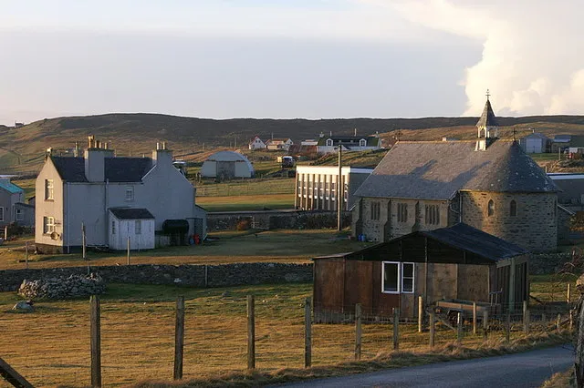 Burravoe The church is on the right, with the school behind it and a view across towards Littlester.