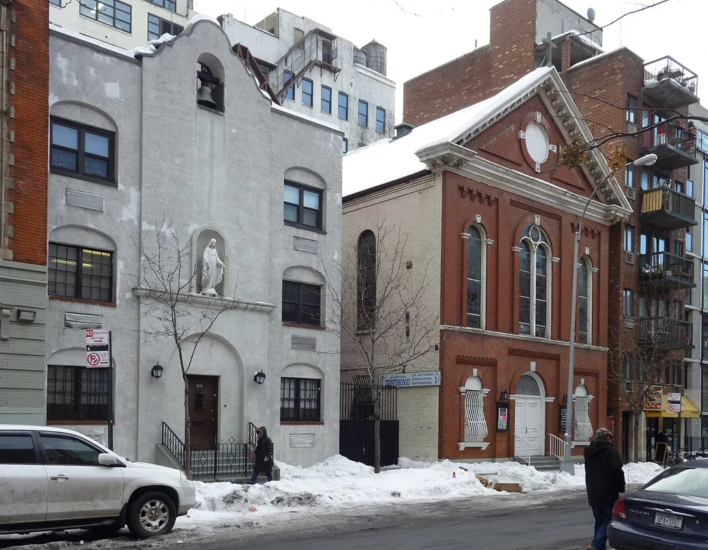 The Church of St. Benedict the Moor is a Roman Catholic parish church in the Roman Catholic Archdiocese of New York, located at 342 West 53rd Street, Manhattan, New York City. It was established in 1883 to serve the African-American community of the city staffed by Spanish friars of the Third Order of St. Francis (T.O.R.) from 1953. The parish was reduced to mission status, and is currently maintained by members of the new Lumen Christi congregation. A three-storey rectory at 338-342 West 53rd Street was built in 1965 to the designs of Joseph Mitchell of 355 West 54th Street for $220,000.