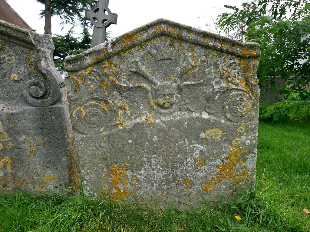 Grade II listed 18th-century headstone immediately south of the headstone of John Howard, located to the south of the Church of Saint Lawrence in Morden. This is a photo of listed building number 1358035.