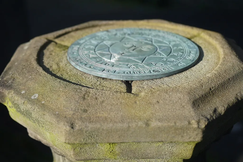 Sundial in front of the south door to the church. Vertical piece or Gnomon appears to be missing at this time.