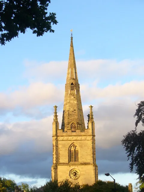 Belfry and spire of St Nicholas' church, Warwick, lit by evening sun