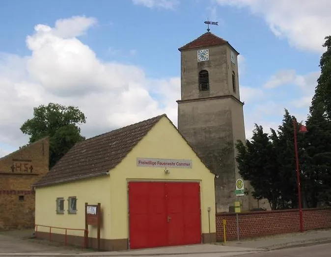 Church and fire station in Cammer. The village Cammer is a part of the municipality Planebruch in the district Potsdam Mittelmark, state Brandenburg, Germany. The village is situated on the northwest border of the Belziger Landschaftswiesen (territory Grassland)/„Baruther Urstromtal“ (glacial valley)/Naturpark Hoher Fläming (natural reserve) subplateau Zauche.