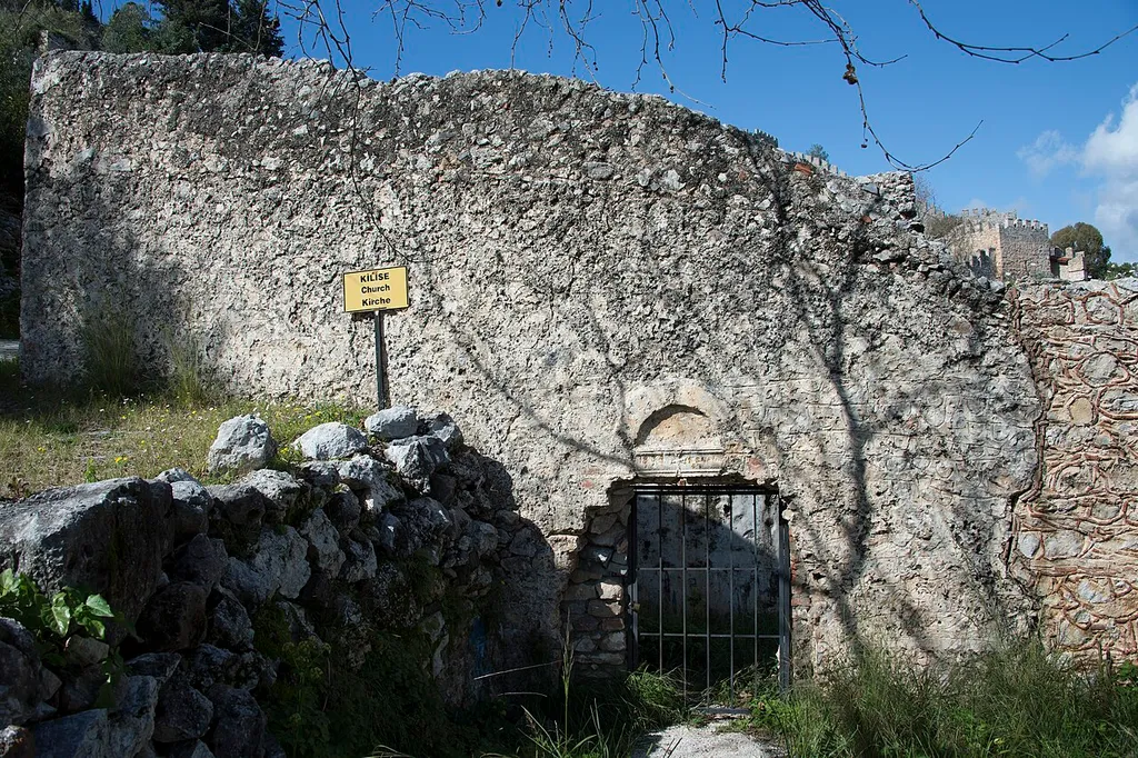 A few meters to the west from the Özel Alaaddin Keykubat Anaokulu (a school) on Kale Caddesi there is the empty shell of a church. I have no information.