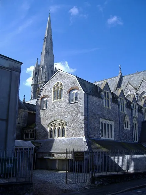 Part of the Dominican convent and former orphanage in St Marychurch, Torquay, Devon, with the spire of the church of Our Lady, Help of Christians and St Denis in the background