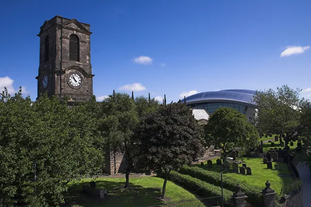 Old And New This depicts old and new buildings on the Tyne. St Marys Church is one of Gatesheads oldest and most important historic buildings. Its beautiful, simple and airy interior makes this the perfect venue for a heritage centre devoted to Gatesheads fascinating past. Whats more, its location high above the Tyne means it offers visitors some of the most spectacular views of Tyneside. Up until 1857, St Marys was the only Anglican church in Gateshead. It was also the only place in the borough where people could legally get married. One of Gatesheads last remaining links to the medieval ages, the church was badly damaged in two separate fires in 1979 and 1983, but was later restored to became an auction room. The Grade I-listed building, perched on the south bank of the Tyne, is now home to the Gateshead Heritage Centre. The Sage music centre can be seen in the background.