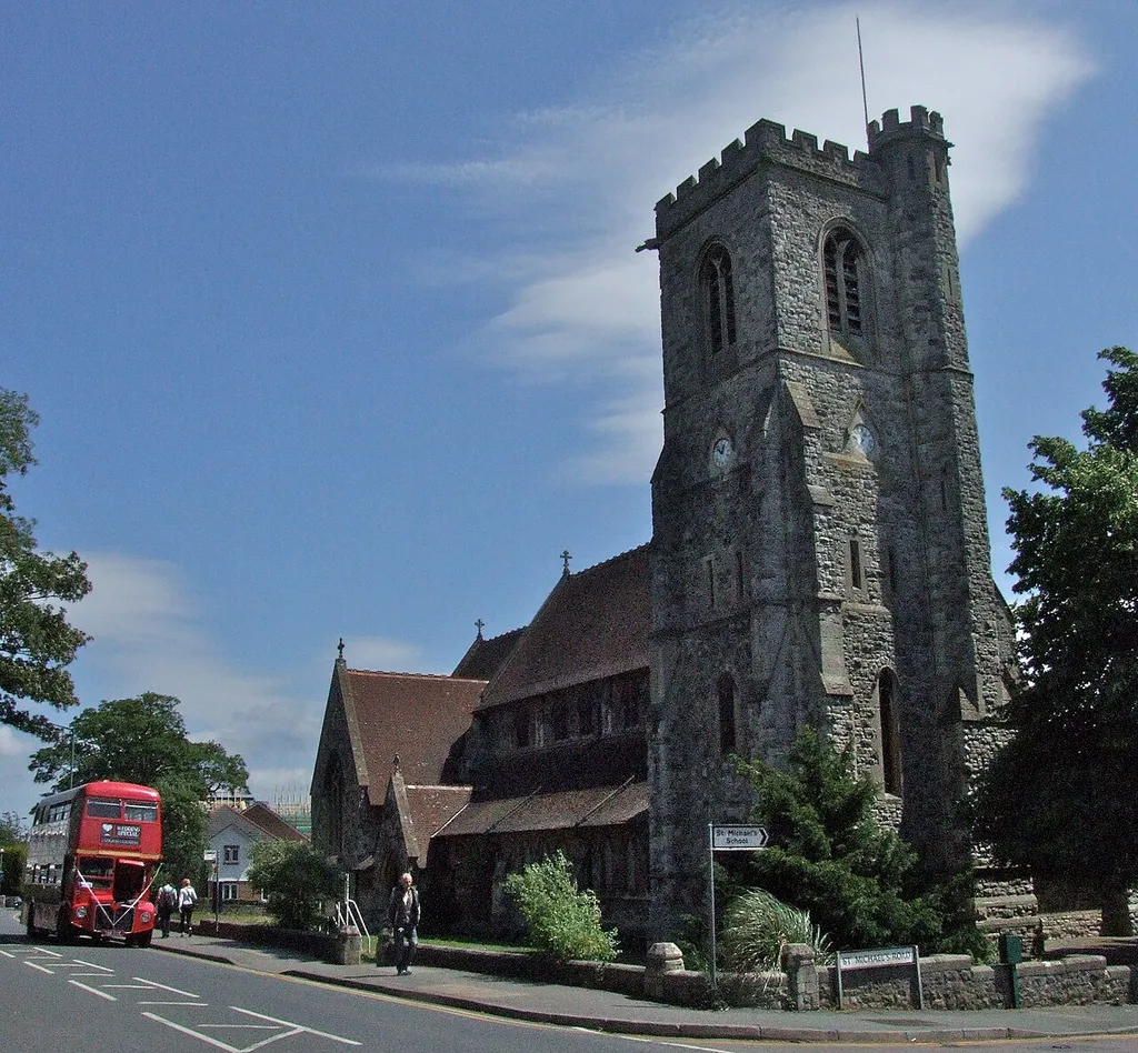St. Michael's and All Angel's Chirch in Maidstone, Kent, England. A Routemaster bus is on a private hire job for a wedding.