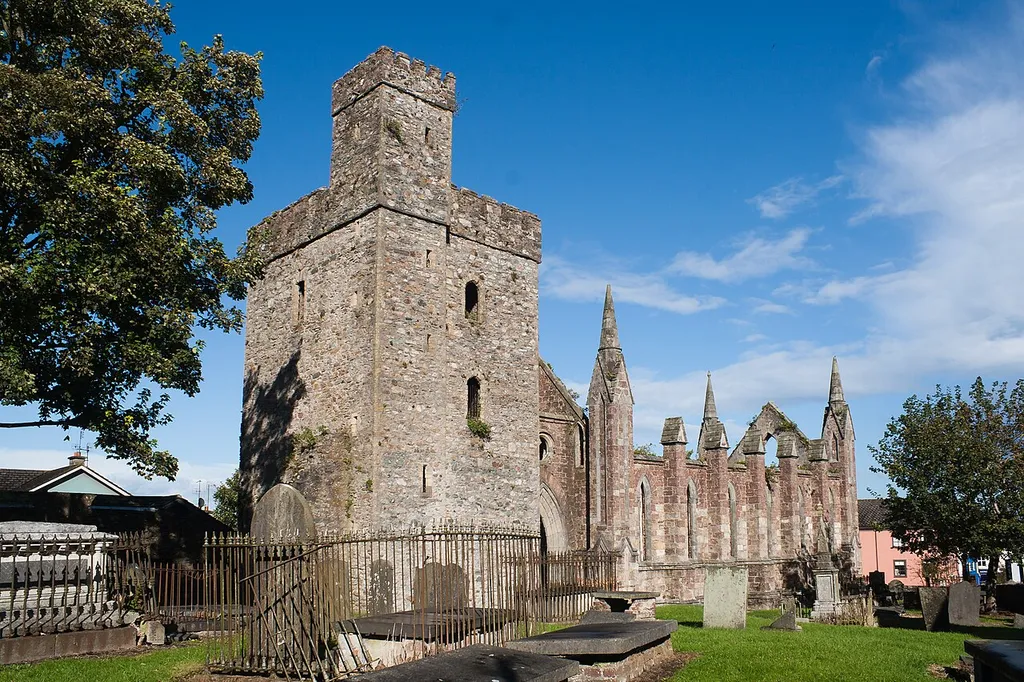 Tower of Selskar Priory (left, restored in the 19th century) and nave with pinnacles of Selskar Church (right, built in the 19th century).