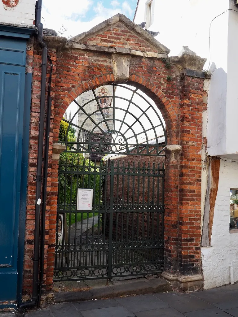 Archway and gates to churchyard of Holy Trinity, Goodramgate, York. Early C18 arch with early C19 gates. Grade II* listed. .mw-parser-output .messagebox{margin:4px 0;width:auto;border-collapse:collapse;border:2px solid var(--border-color-progressive,#6485d1);background-color:var(--background-color-neutral-subtle,#fbfcff);color:var(--color-base,#202122);box-sizing:border-box;border-inline-start-width:8px}.mw-parser-output .messagebox.mbox-small{font-size:88%;line-height:1.25em}.mw-parser-output .mbox-warning,.mw-parser-output .mbox-speedy{border:2px solid var(--border-color-error,#b22222);background:var(--background-color-error-subtle,#ffdbdb);border-inline-start-width:8px}.mw-parser-output .mbox-serious,.mw-parser-output .mbox-delete,.mw-parser-output .mbox-stop{border:2px solid var(--border-color-error,#b22222);border-inline-start-width:8px}.mw-parser-output .mbox-issue,.mw-parser-output .mbox-content{border:2px solid #f28500;background:var(--background-color-warning-subtle,#ffe);border-inline-start-width:8px}.mw-parser-output .mbox-query,.mw-parser-output .mbox-style{border:2px solid #f4c430;background:var(--background-color-warning-subtle,#ffe);border-inline-start-width:8px}.mw-parser-output .mbox-shit{border:2px solid #960;border-inline-start-width:8px}.mw-parser-output .mbox-license{border:2px solid #88a;border-inline-start-width:initial}.mw-parser-output .mbox-legal{border:2px solid var(--border-color-notice,#666);background:var(--background-color-base,#fff);border-inline-start-width:8px}.mw-parser-output .mbox-honor{border:2px solid #ca3;background:var(--background-color-warning-subtle,#fcf4db);border-inline-start-width:8px}.mw-parser-output .mbox-growth{border:2px solid #8d4;background:var(--background-color-success-subtle,#d5fdf4);border-inline-start-width:8px}.mw-parser-output .mbox-move{border:2px solid #93c;border-inline-start-width:8px}.mw-parser-output .mbox-protection,.mw-parser-output .mbox-message{border:2px solid var(--border-color-base,#aaa);borde