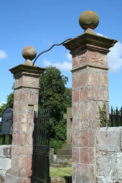 Gates to St Mary's parish churchyard, Tilston, Cheshire. The gateway was built in 1688 as a memorial, hence the skull and crossbones reliefs and the inscription "Memento Mori, IP 1687 IL".