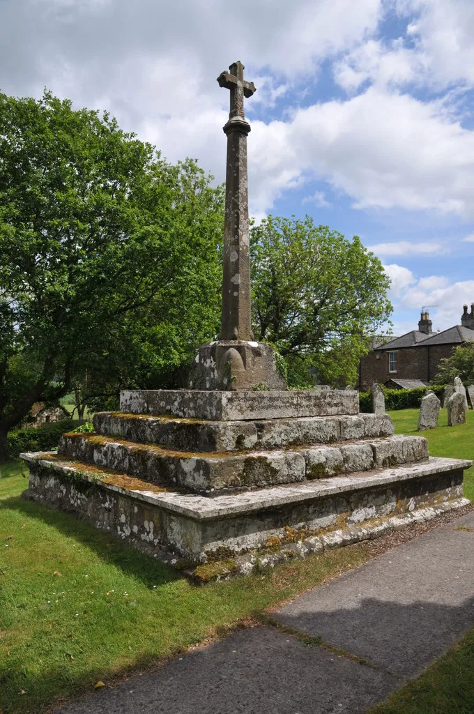 Stone cross in the parish churchyard of St Thomas Becket, Wolvesnewton, Monmouthshire. A Mediæval churchyard cross, restored about 1920 as a First World War monument.