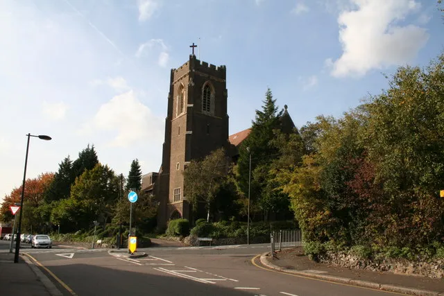 St. Andrew's parish church, Coulsdon, south London (formerly Surrey), seen from the east from The Avenue. The crossroads is with the A327 Woodcote Grove Road (left – right), beyond which is Woodmansterne Road.