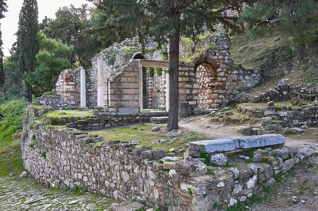 "It was probably built in the first period of Turkish domination (1458-1687). The church is of the cross-in-square type with a dome supported on four monolithic columns with bases and capitals of the Ionic order in second use, while the floor was paved with stone slabs. The central entrance of the church was a stone door flame with carved decoration restored in 2001, and at the right doorway, as in all apertures, there are pointed arches. The south aisle (sacristy), with groin-vaults. In its niche, there was a wall painting with the symbol of the cross. In the south-west corner of the church, itself can be distinguished as an angled porous- stoned niche of Turkish type with 'stalactite' decor. The church, despite late alterations and additions, preserves, in certain parts of its wall construction, the cloisonne masonry, a system with thin tiles and thick mortar. In its original phase, the church served as the central place of worship (?Katholikon? ) for a small monastic community, of which there are preserved, immediately on the west: the cistern, the water tanks, the fountain, the courtyard, as well as the vaulted rooms on the southwest side of the 'katholikon,' which served as a section of an arched colonnade on the ground-floor that today has mostly disappeared. In the 18th century, a section of the Hypapanti Fortification Wall was constructed joining the east side of the church, which also was converted into a bastion with battlements securing the north gate of the wall, the well-known "Bastion of the Lion." Source: Hellenic Ministry of Culture and Sports Link: http://odysseus.culture.gr/h/2/eh251.jsp?obj_id=19814