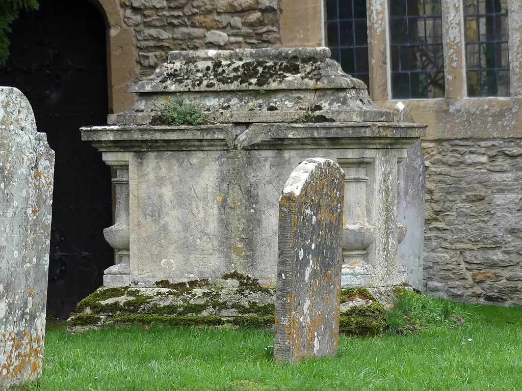 Grade II listed building in the churchyard of St Mary the Virgin's Church, Bampton, Oxfordshire. Listed as "Chest tomb to George Knapp, in churchyard of St Mary's circa 5 metres north of north aisle". .mw-parser-output .messagebox{margin:4px 0;width:auto;border-collapse:collapse;border:2px solid var(--border-color-progressive,#6485d1);background-color:var(--background-color-neutral-subtle,#fbfcff);color:var(--color-base,#202122);box-sizing:border-box;border-inline-start-width:8px}.mw-parser-output .messagebox.mbox-small{font-size:88%;line-height:1.25em}.mw-parser-output .mbox-warning,.mw-parser-output .mbox-speedy{border:2px solid var(--border-color-error,#b22222);background:var(--background-color-error-subtle,#ffdbdb);border-inline-start-width:8px}.mw-parser-output .mbox-serious,.mw-parser-output .mbox-delete,.mw-parser-output .mbox-stop{border:2px solid var(--border-color-error,#b22222);border-inline-start-width:8px}.mw-parser-output .mbox-issue,.mw-parser-output .mbox-content{border:2px solid #f28500;background:var(--background-color-warning-subtle,#ffe);border-inline-start-width:8px}.mw-parser-output .mbox-query,.mw-parser-output .mbox-style{border:2px solid #f4c430;background:var(--background-color-warning-subtle,#ffe);border-inline-start-width:8px}.mw-parser-output .mbox-shit{border:2px solid #960;border-inline-start-width:8px}.mw-parser-output .mbox-license{border:2px solid #88a;border-inline-start-width:initial}.mw-parser-output .mbox-legal{border:2px solid var(--border-color-notice,#666);background:var(--background-color-base,#fff);border-inline-start-width:8px}.mw-parser-output .mbox-honor{border:2px solid #ca3;background:var(--background-color-warning-subtle,#fcf4db);border-inline-start-width:8px}.mw-parser-output .mbox-growth{border:2px solid #8d4;background:var(--background-color-success-subtle,#d5fdf4);border-inline-start-width:8px}.mw-parser-output .mbox-move{border:2px solid #93c;border-inline-start-width:8px}.mw-parser-output .mbox-protection,.mw-pa