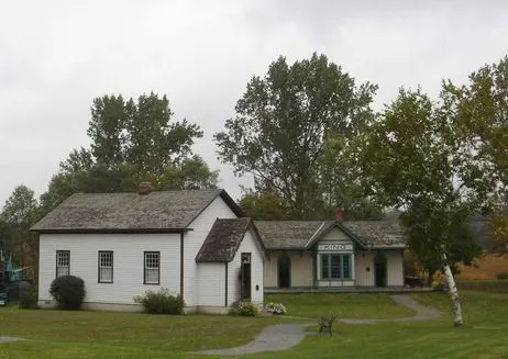 King Station (green and cream yellow building) and King Christian Church (white building) on the grounds of King Township Museum.