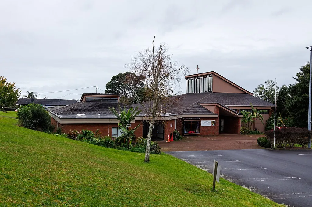 View of St Thomas More Church in Glenfield, Auckland, on a cloudy day.